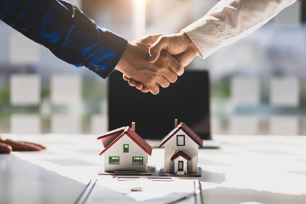 Real estate professionals shaking hands